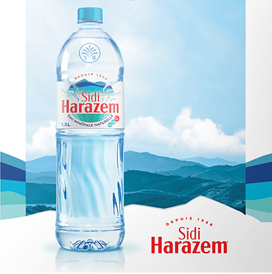 Sidi Harazem 1.5L mineral water bottle labeled "Eau Minérale Naturelle" with mountains and cloudy sky in background